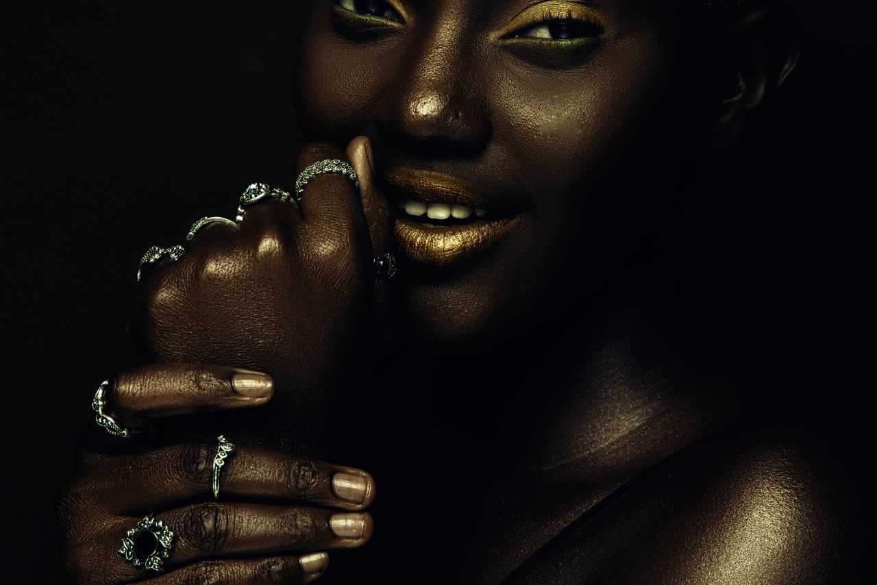 A close-up of a woman wearing a stunning selection of rings stacked around her engagement ring.