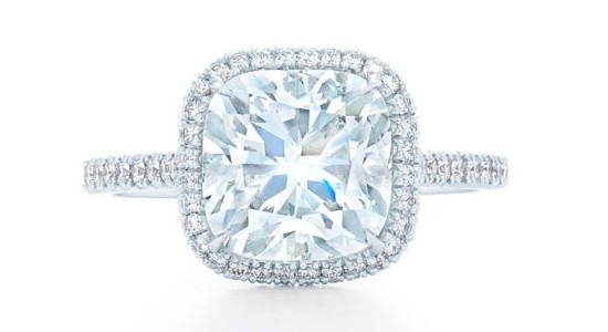 A white gold engagement ring with a large center stone and halo and side stone setting.