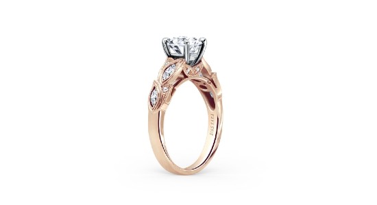 A Kirk Kara mixed metal engagement ring featuring leaf motifs and milgrain detail.