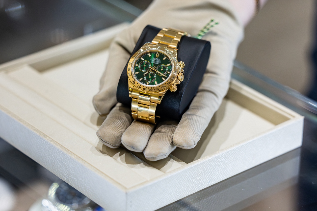A professional in Morgan&rsquo;s Jewelers holding a luxury watch with a protective glove