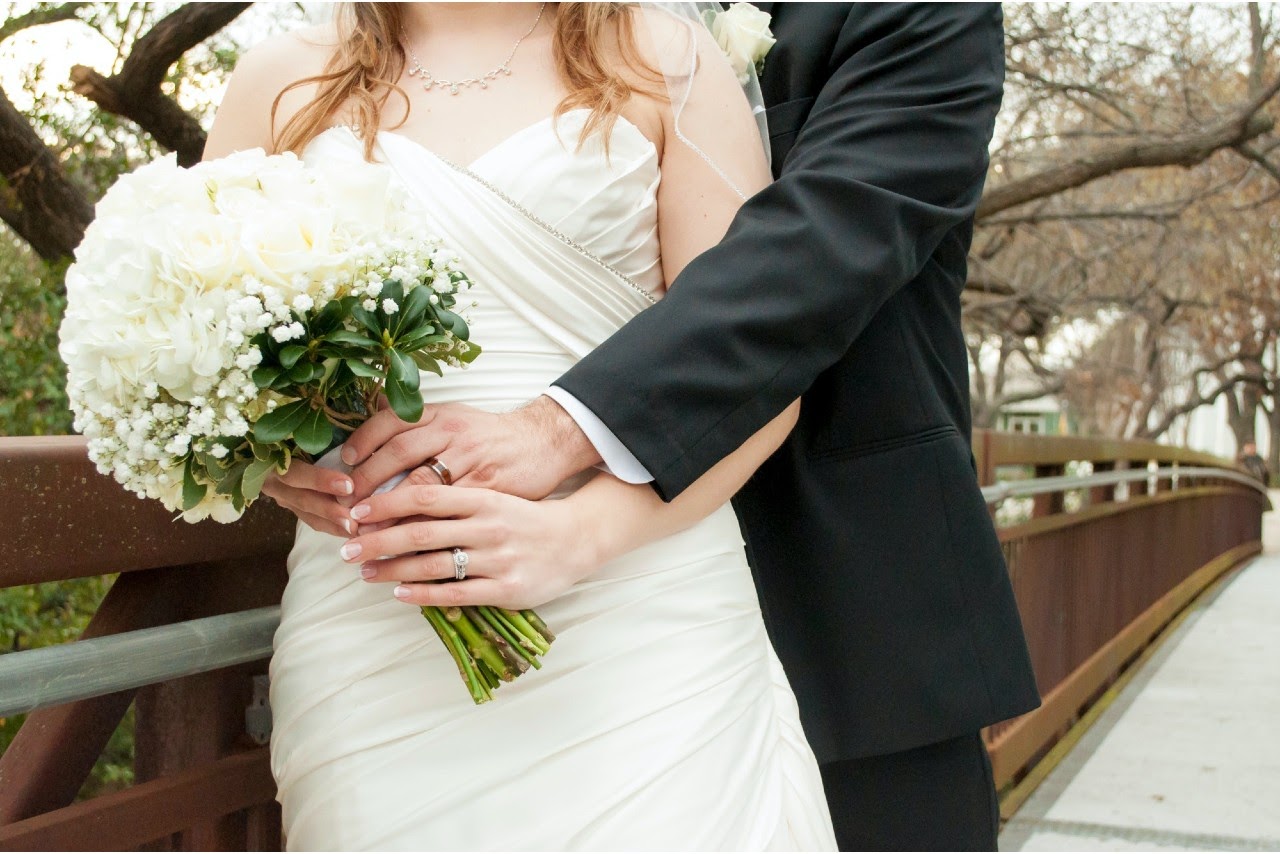 Couple hugging, wife holds a bouquet of flowers Couple hugging, wife holds a bouquet of flowers