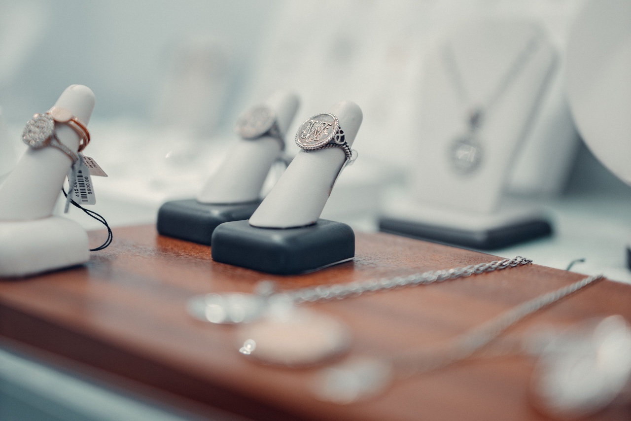A jewelry showcase full of silver and gold embroidered diamond rings.