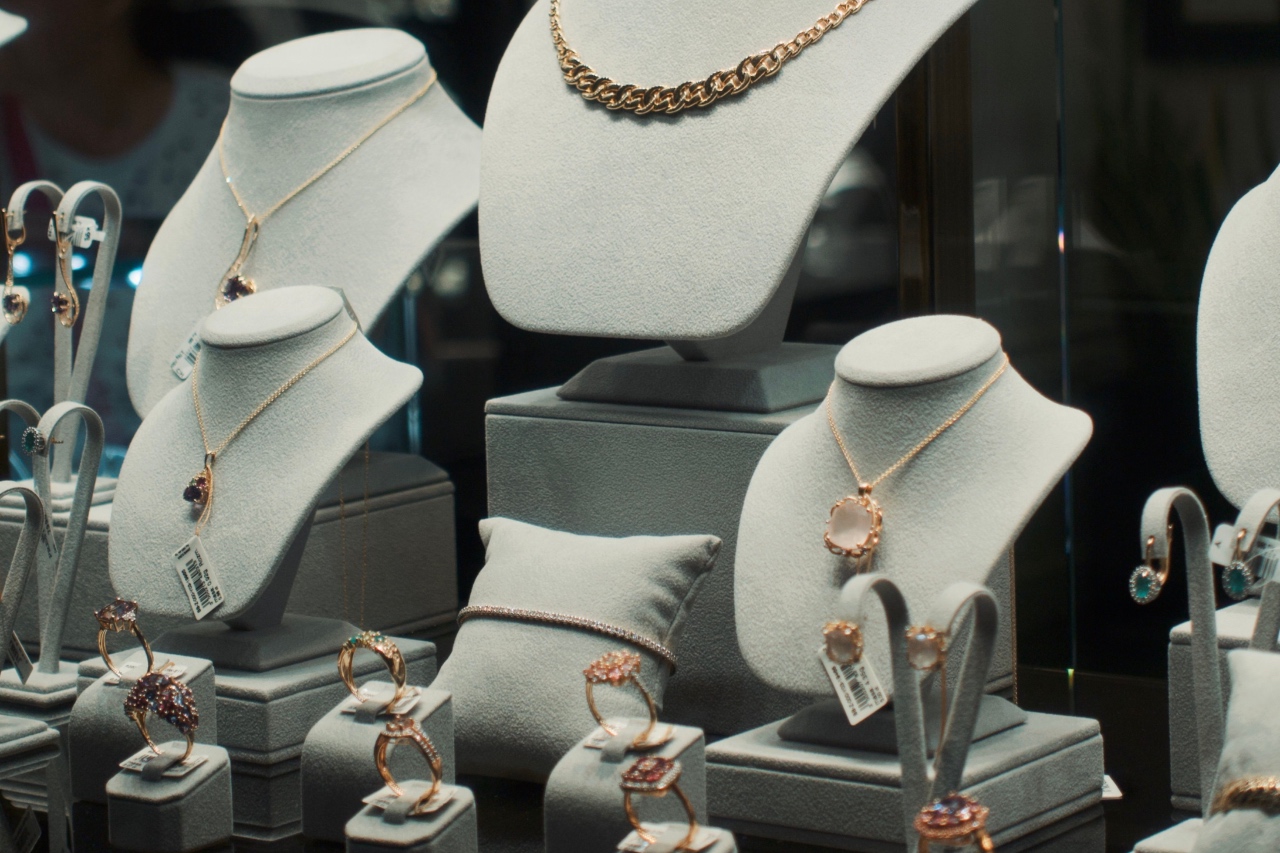 A showcase of a gemstone jewelry collection on elegant displays inside a lit boutique window. A showcase of a gemstone jewelry collection on elegant displays inside a lit boutique window.