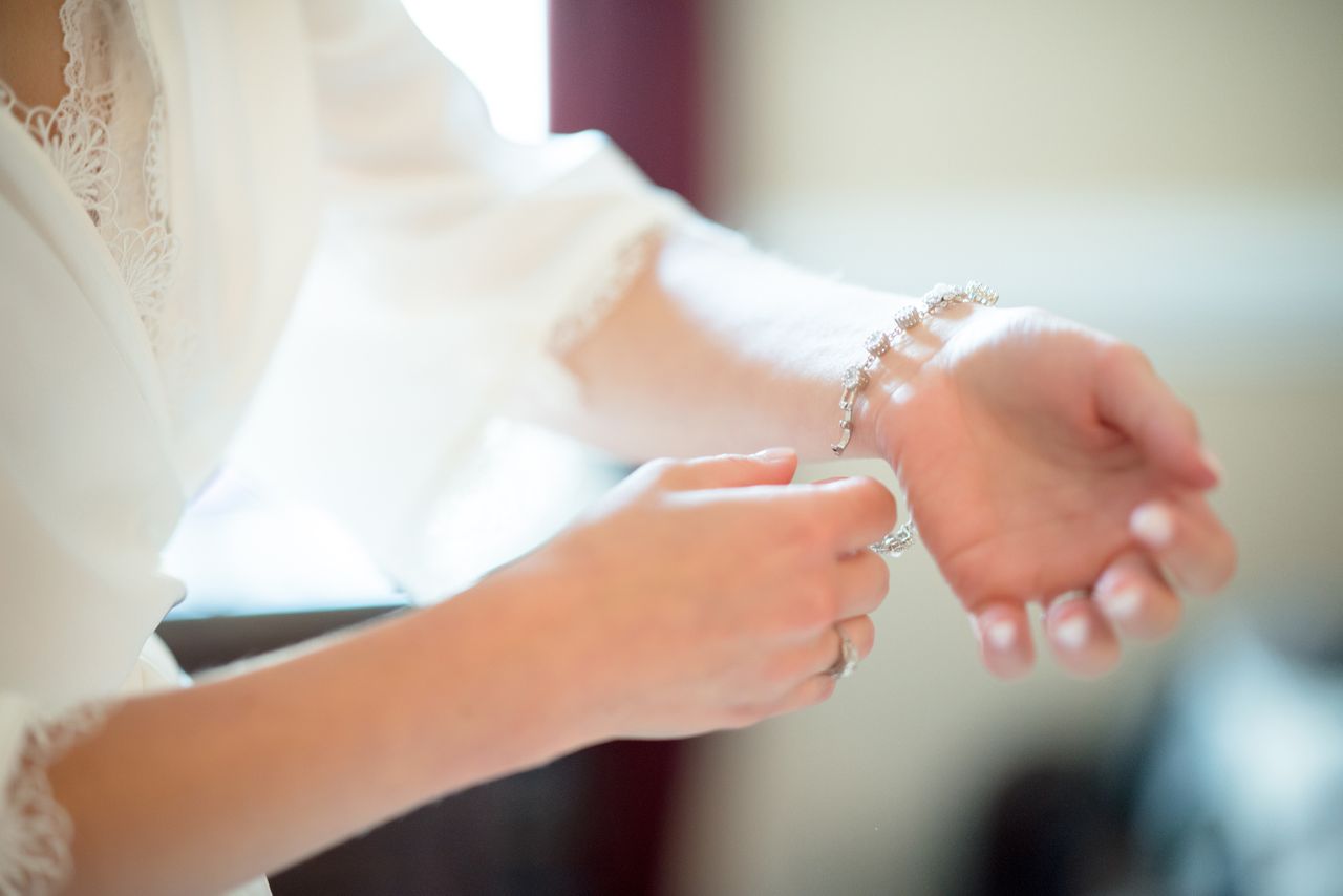 A woman putting on a diamond bracelet A woman putting on a diamond bracelet